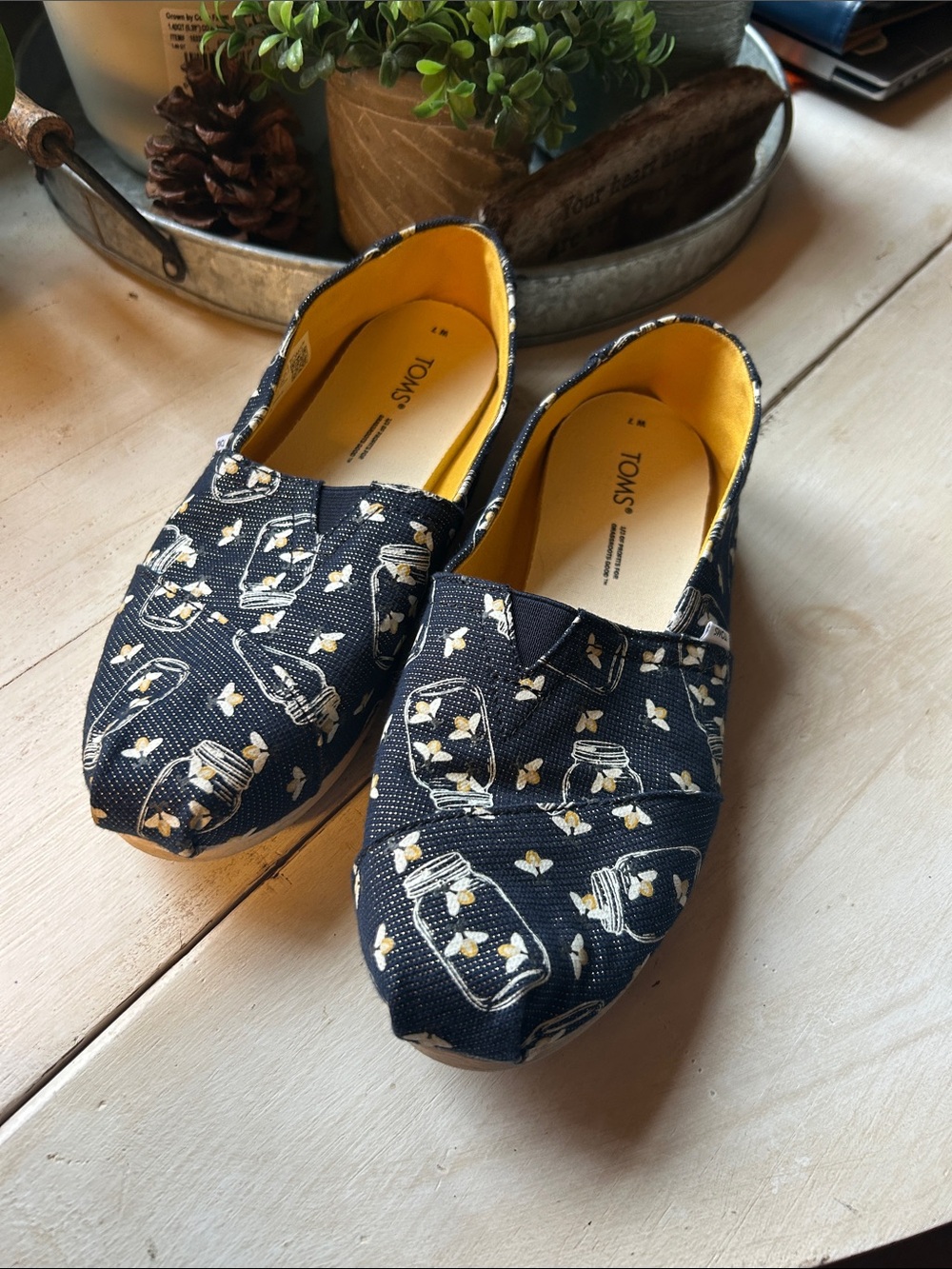 TOMS Navy Canvas Slip-Ons with Yellow firefly Jar Print